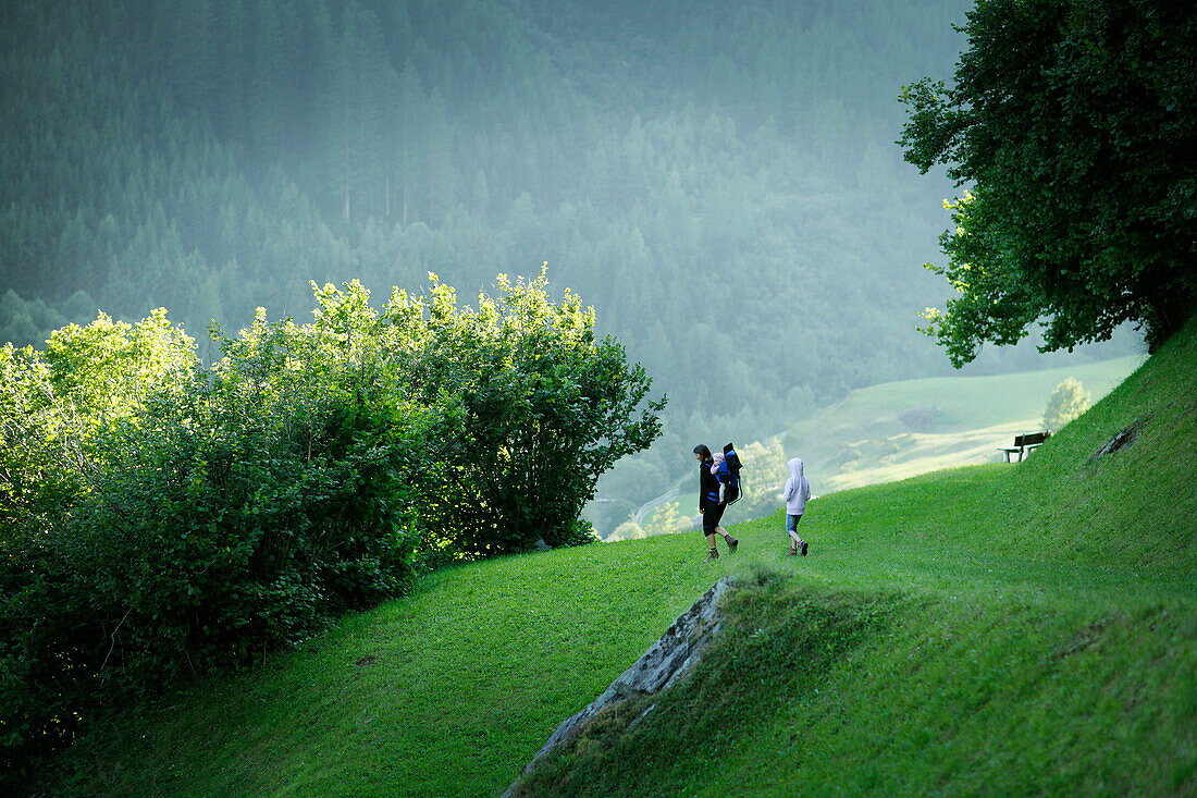 Woman and children crossing meadow, Val di Fleres, South Tyrol, Trentino-Alto Adige/Südtirol, Italy