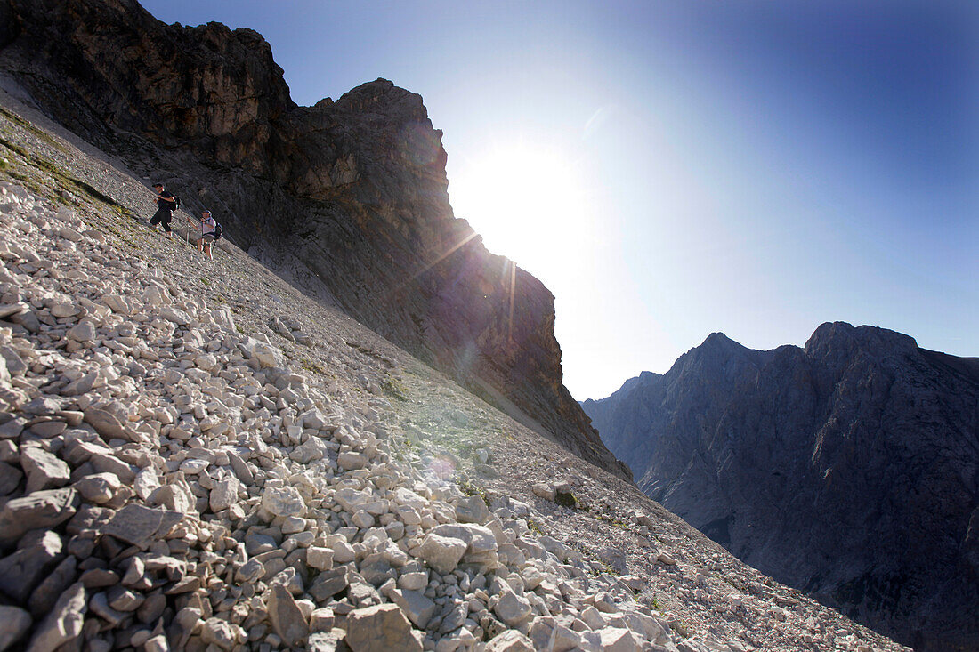 Two hikers ascenting mount Zugspitze, Wetterstein Range, Bavaria, Germany