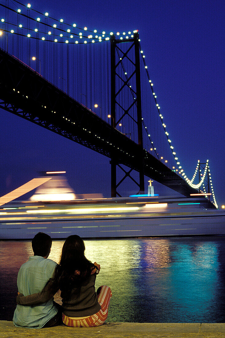 Couple Under The 25Th Of April Bridge, Lisbon, Portugal