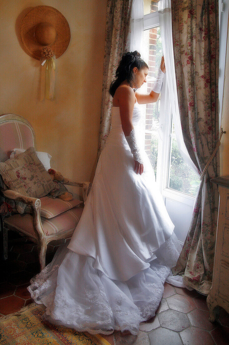 Bride In A White Gown Next To A Window, Preparations For The Wedding, France