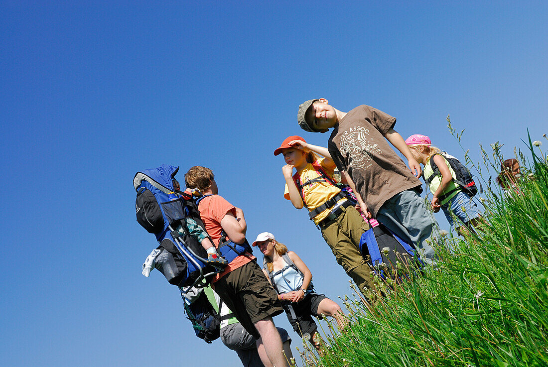 Group of hikers with children standing on pasture, Bavarian Alps, Upper Bavaria, Bavaria, Germany