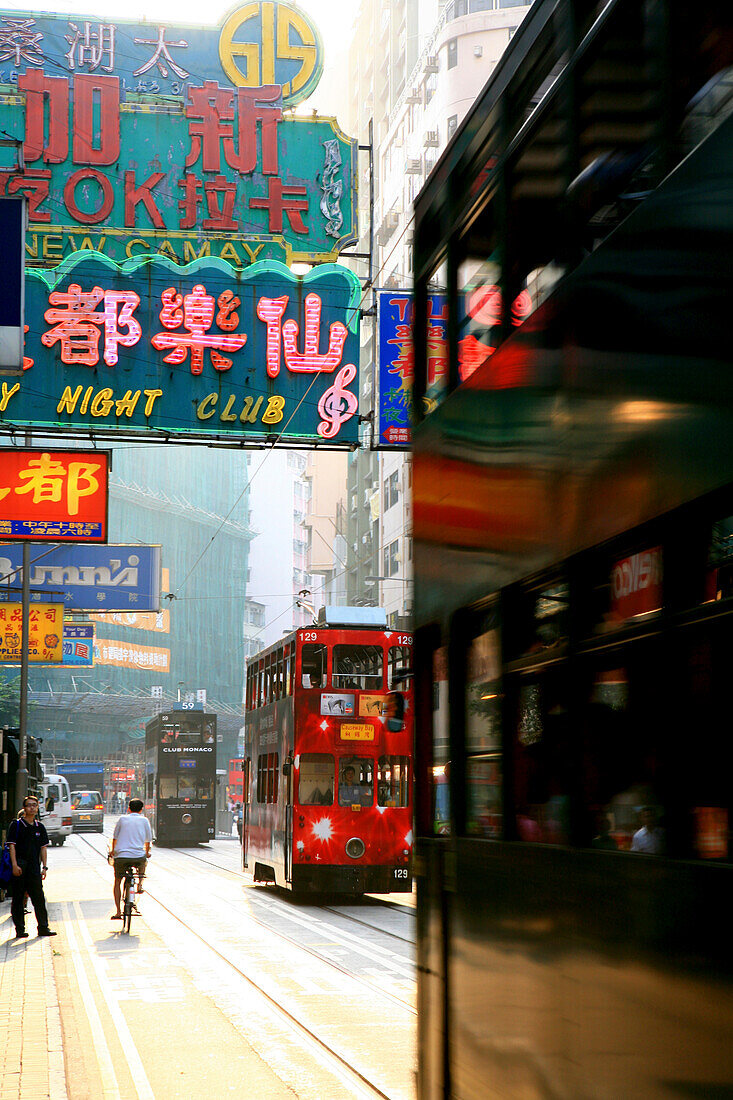 Double decker tram and neon signs in a street, Hong Kong, China