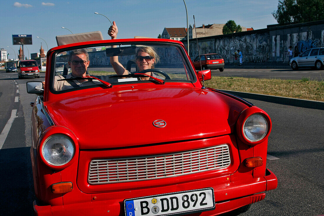 Couple Touring Berlin In A Trabant, The Family Car Of The Ex-Ddr Become A Cult Symbol Of East Germany, Trabi Safari, And East Side Gallery, Berlin, Germany
