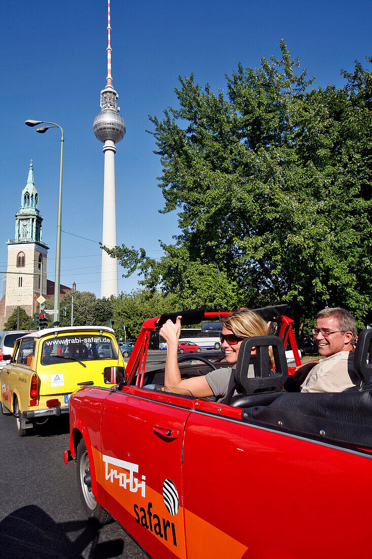 Couple Touring Berlin In A Trabant, The Family Car Of The Ex-Ddr Become A Cult Symbol Of East Germany, Trabi Safari, And Television Tower Berlin, Germany