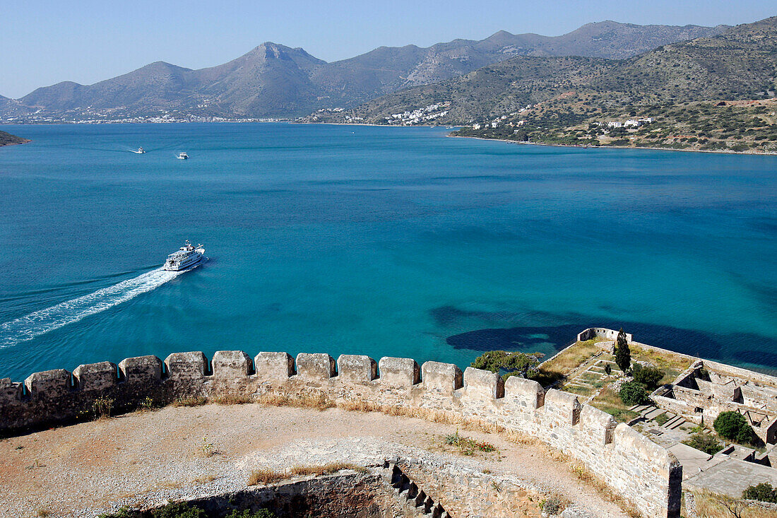 Venetian Fortress On The Isle Of Spinalonga And Boat In The Gulf Of Mirabello, Crete, Greece