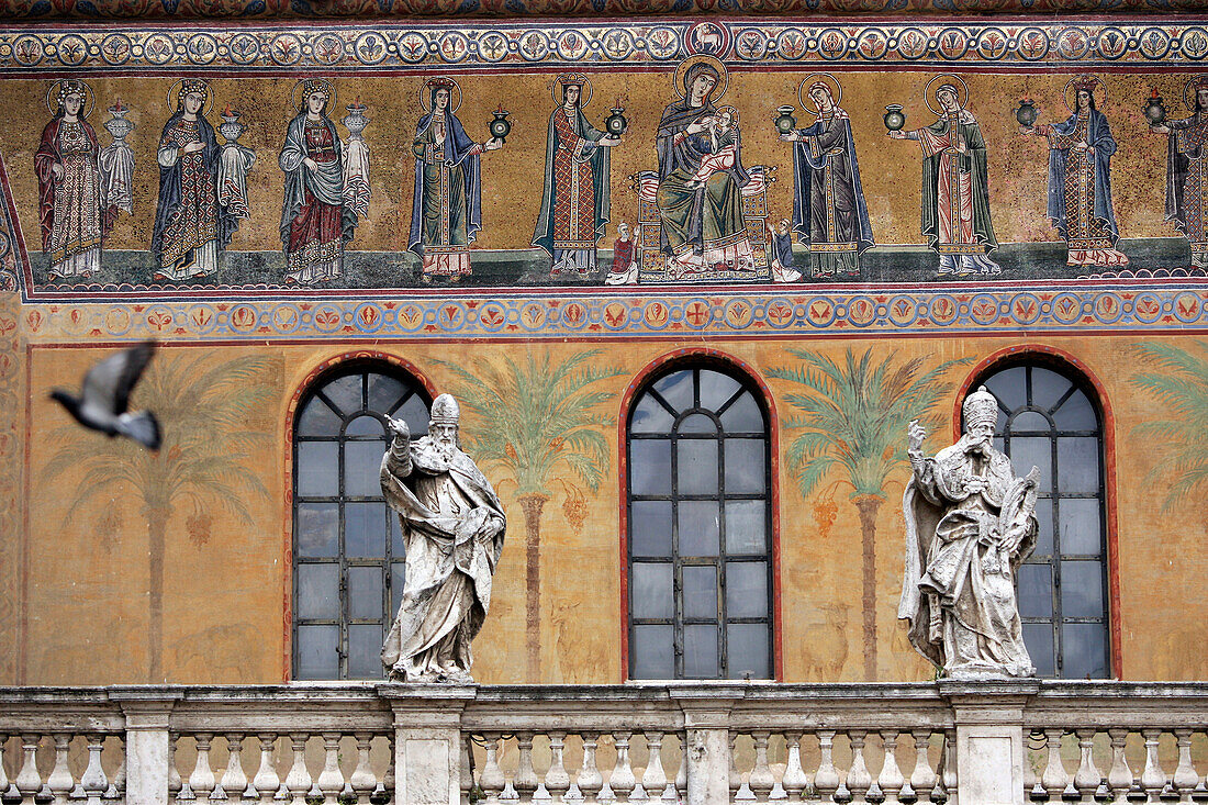 Facade Of The Santa Maria In Trastevere Church With Its 12Th Century Mosaics In The Background And Statues Of The Popes Surmounting The Portico'S Balustrade, Rome, Italy