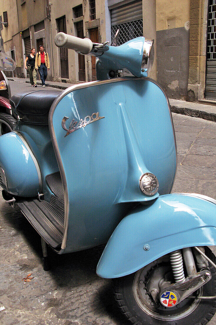 Blue Vespa On A Small Street In Florence, Tuscany, Italy