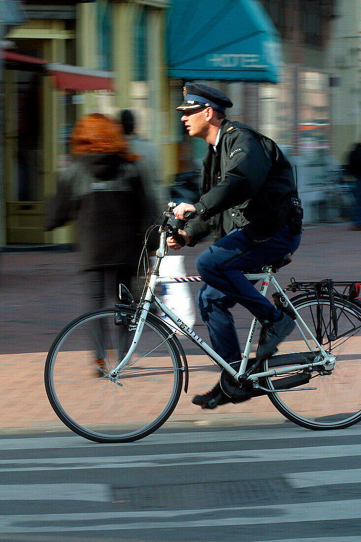 Policeman On A Bicycle, Amsterdam, Netherlands