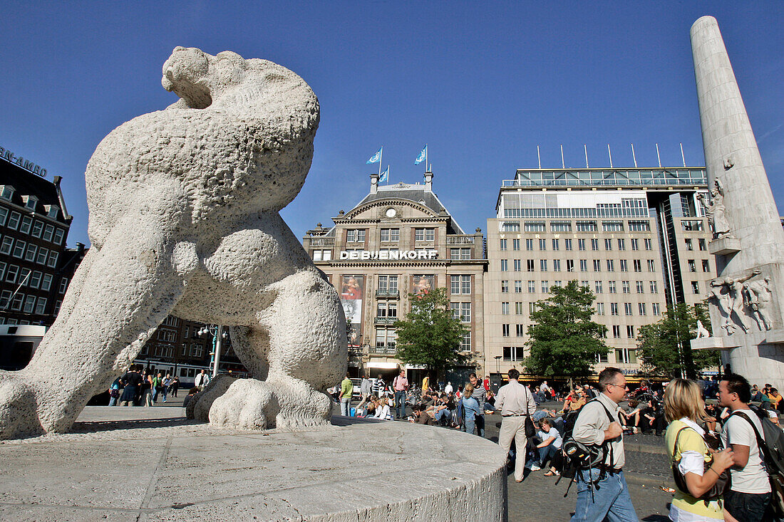 Statue Of The Lion And Tramway In Front Of The Facade Of Deb'Jenkorf, Dam Square, Amsterdam, Netherlands