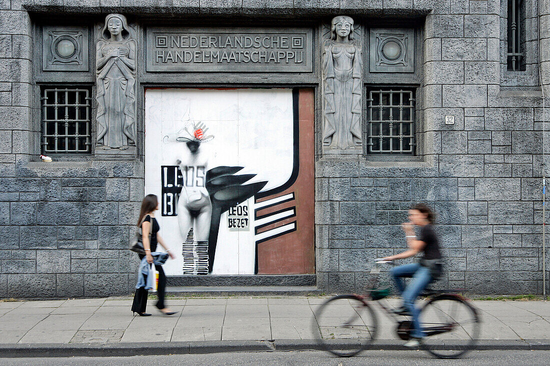 Bicycles And Passers-By In Front Of The Facade Of The Building Designed By K. De Bazel, Amsterdam, Netherlands