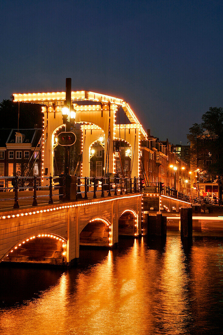 The Skinny Bridge, 'Magere Brug', The Most Famous Of The 1280 Bridges In Amsterdam. A Traditional Wood, Double-Swipe Bridge Linking The Two Sides Of The Amstel, Amsterdam, Netherlands