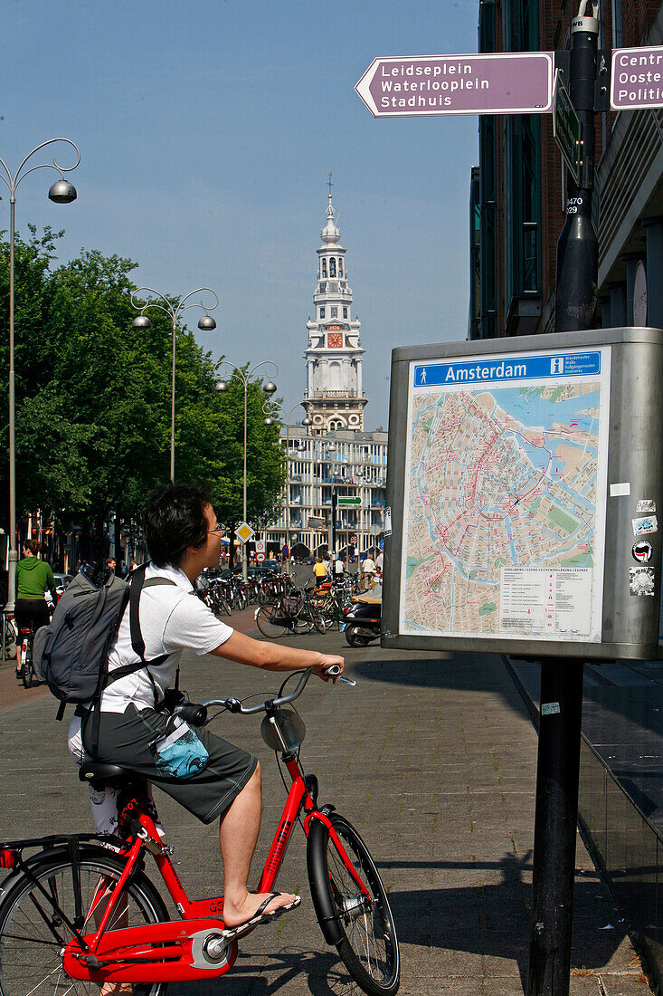 Tourist On A Bicycle In Front Of A Map Of The City, Jodenbreestraat Street, South Church, Zuiderkerk