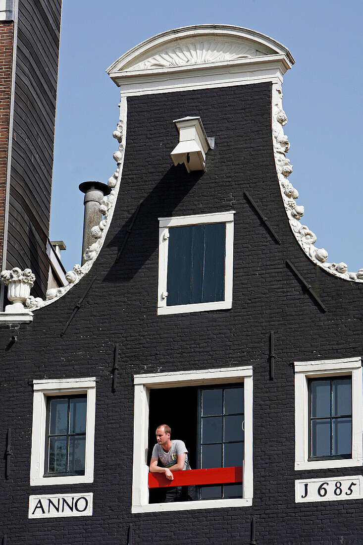 Man At The Window, Traditional House Facade Along The Canals, Amsterdam, Netherlands, Holland