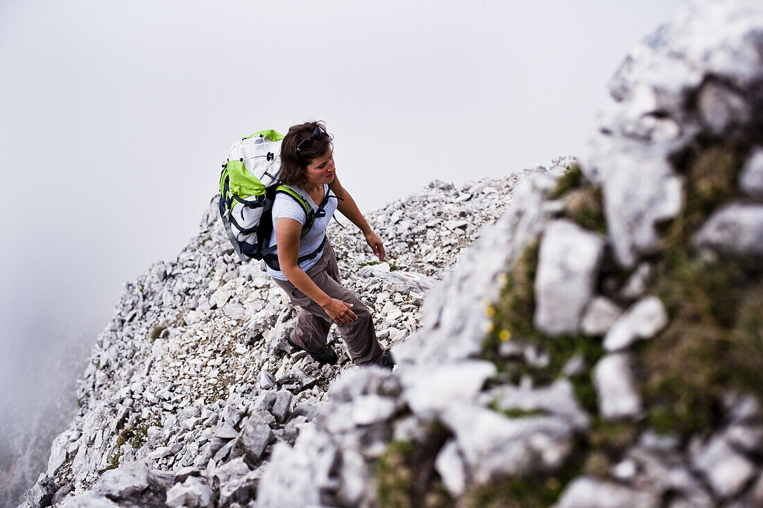 Woman ascenting Sonntagkarspitze, Innsbruck, Karwendel range, Tyrol, Austria