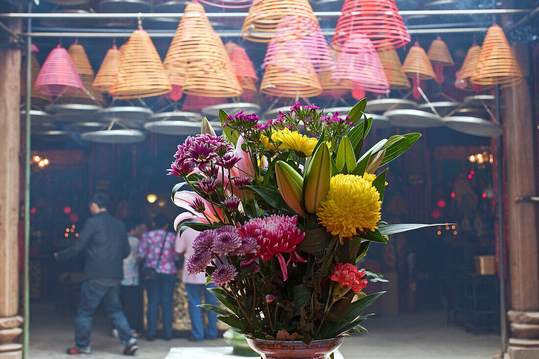 Colourful flowers and people at a temple, Wanchai, Hongkong, China, Asia