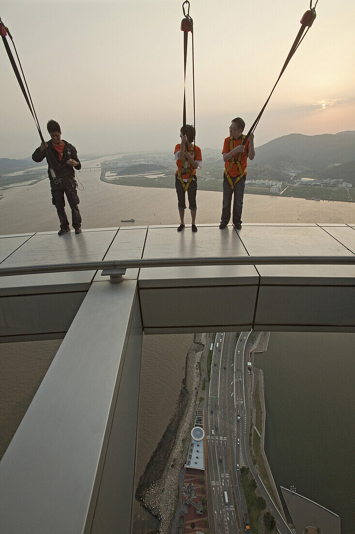 People with ropes on viewing platform of the Macao Tower at sunset, Macao, China, Asia