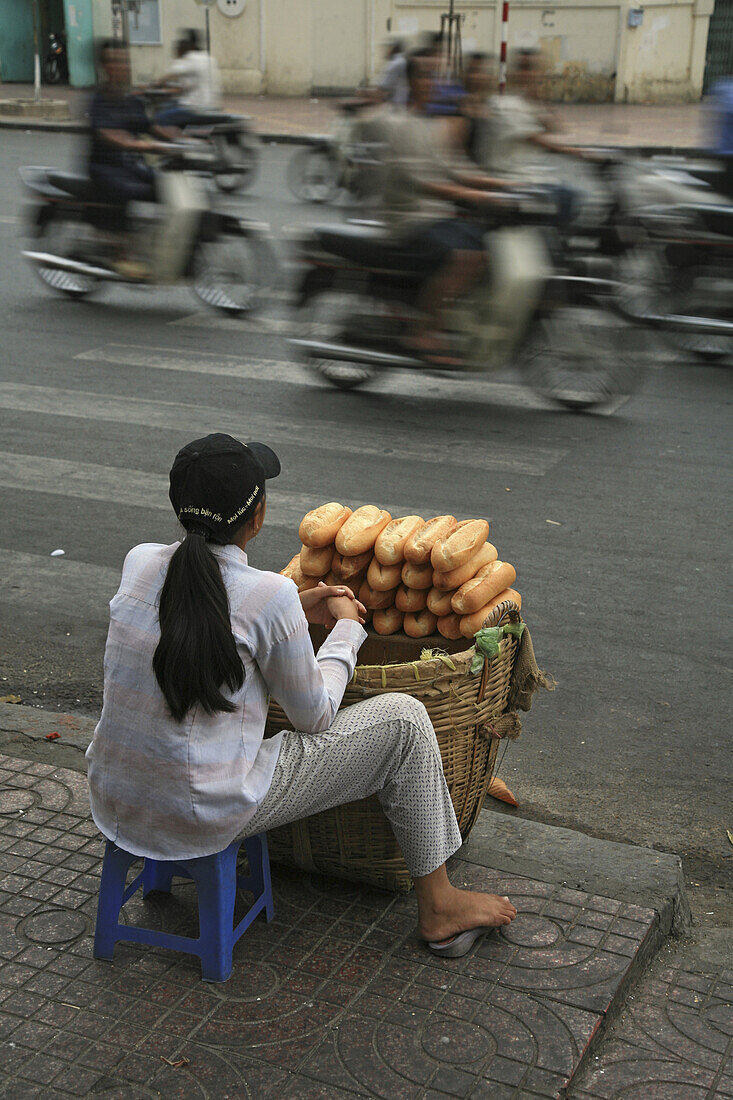 French bread vendor on the roadside during Tet festival, Saigon, Ho Chi Minh City, Vietnam, Asia