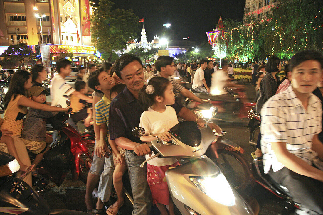 People driving scooters during the Tet festival at night, Saigon Ho Chi Minh City, Vietnam, Asia