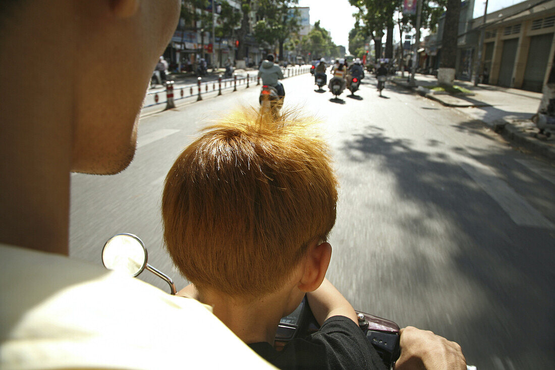 Father and son driving moped, Saigon, Ho Ch minh City, Vietnam, Asia