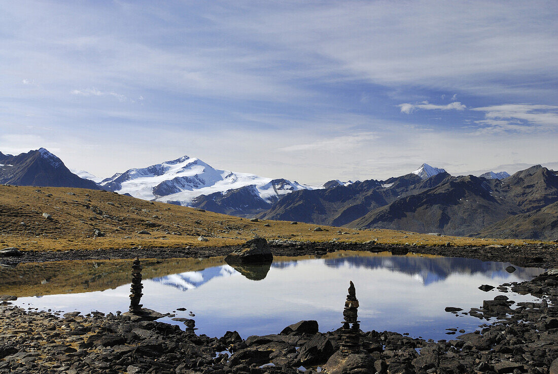 Cairns near mountain lake Schwarzes Loch, valley Zufritt, Ortler range, South Tyrol, Italy