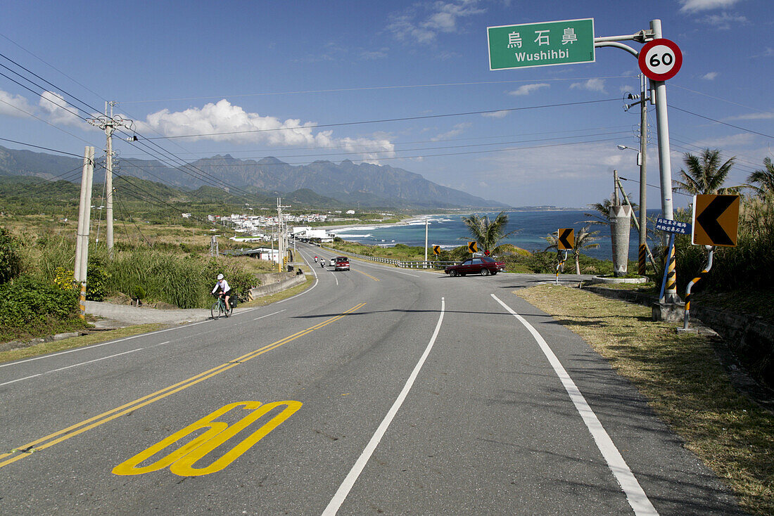 Cyclist on coast road in the sunlight, Highway No 11, Wushihbi, Republic of China, Taiwan, Asia