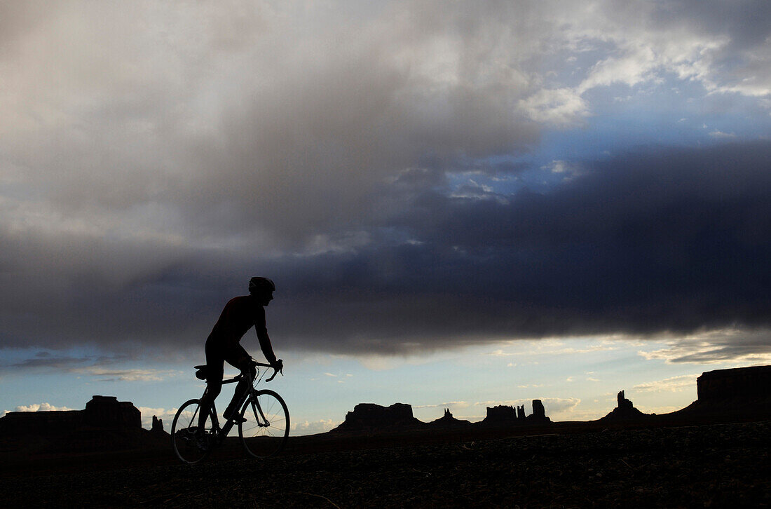 Racing cyclist, Monument Valley, Navajo Tribal Lands, Utah, USA