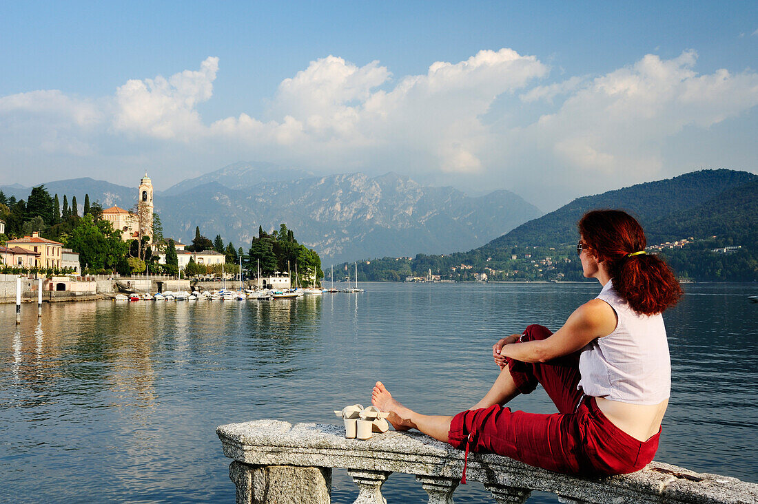 Woman enjoying view over Lake Como to Tremezzo, Lombardy, Italy