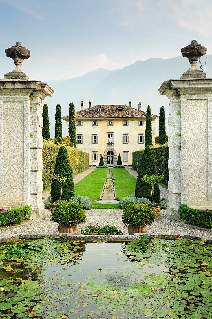 Fountain and garden with villa at Lake Como, Lombardy, Italy