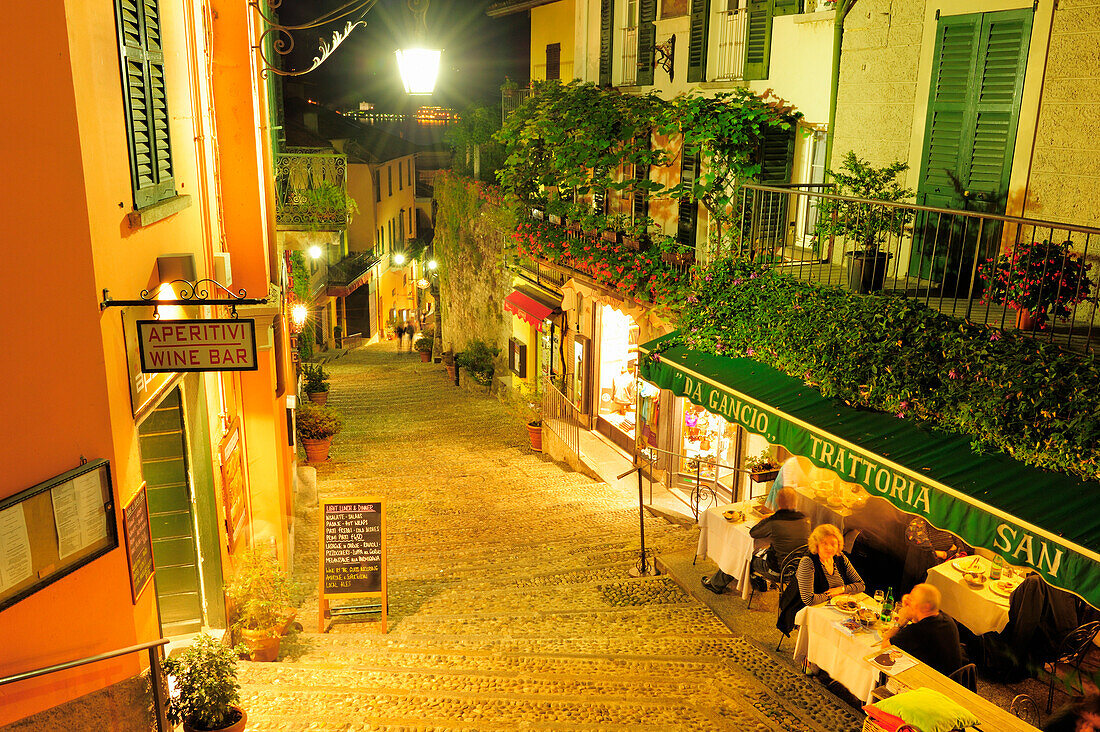 Illuminated alley with restaurants, Bellagio, Lake Como, Lombardy, Italy