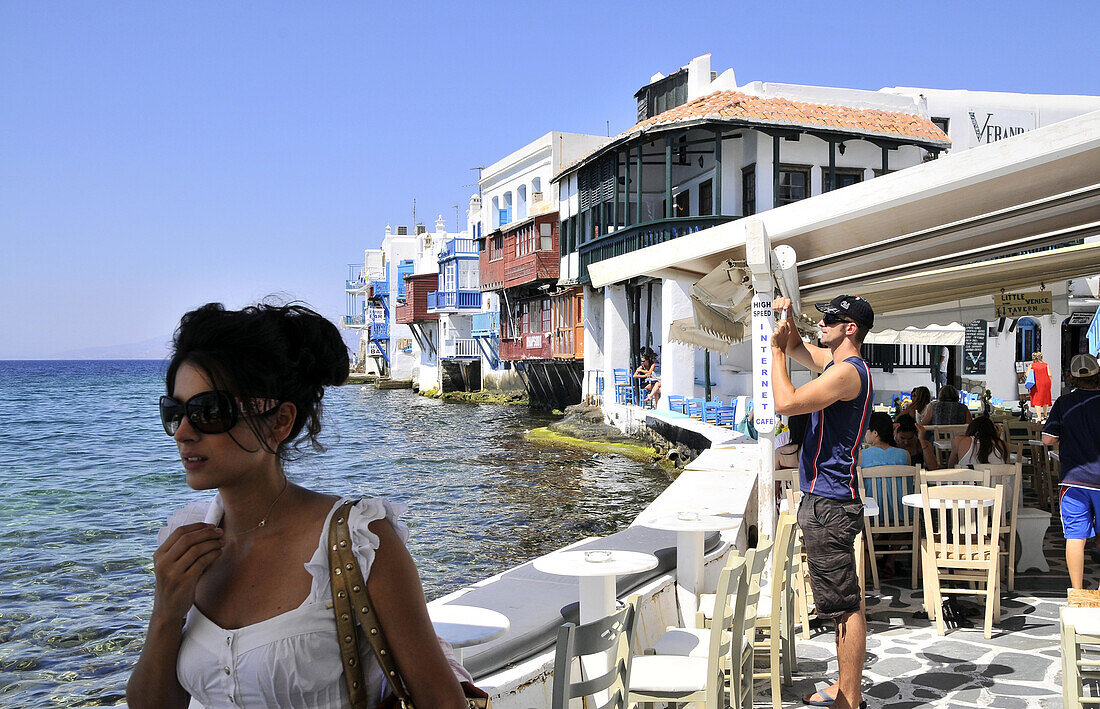 People at cafes at Venetia quarter, Mykonos island, Cyclades, Greece, Europe