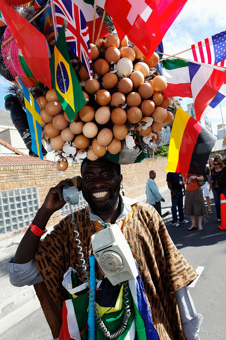 Man with telephone and flags, Football world cup final draw, 04.12.2009, fans celebrate the drawing of the first round, Long street, Capetown, Western Cape, South Africa, Africa