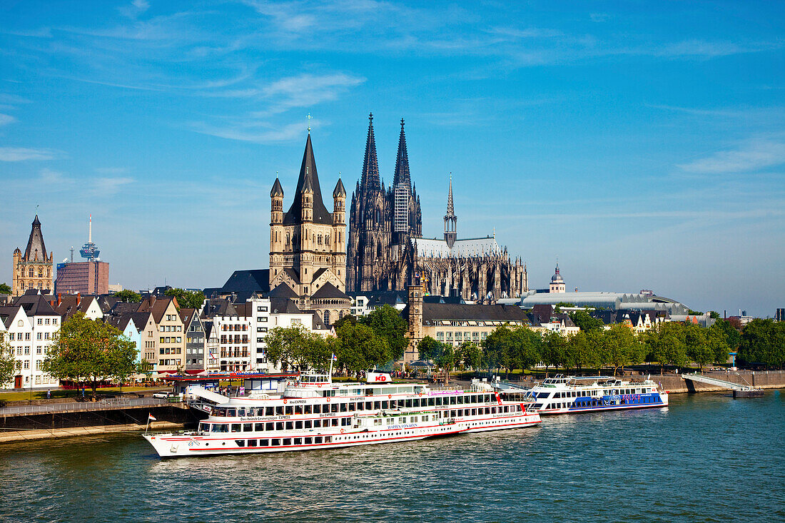View over river Rhine to old town with cathedral and Great St. Martin church, Cologne, North Rhine-Westphalia, Germany