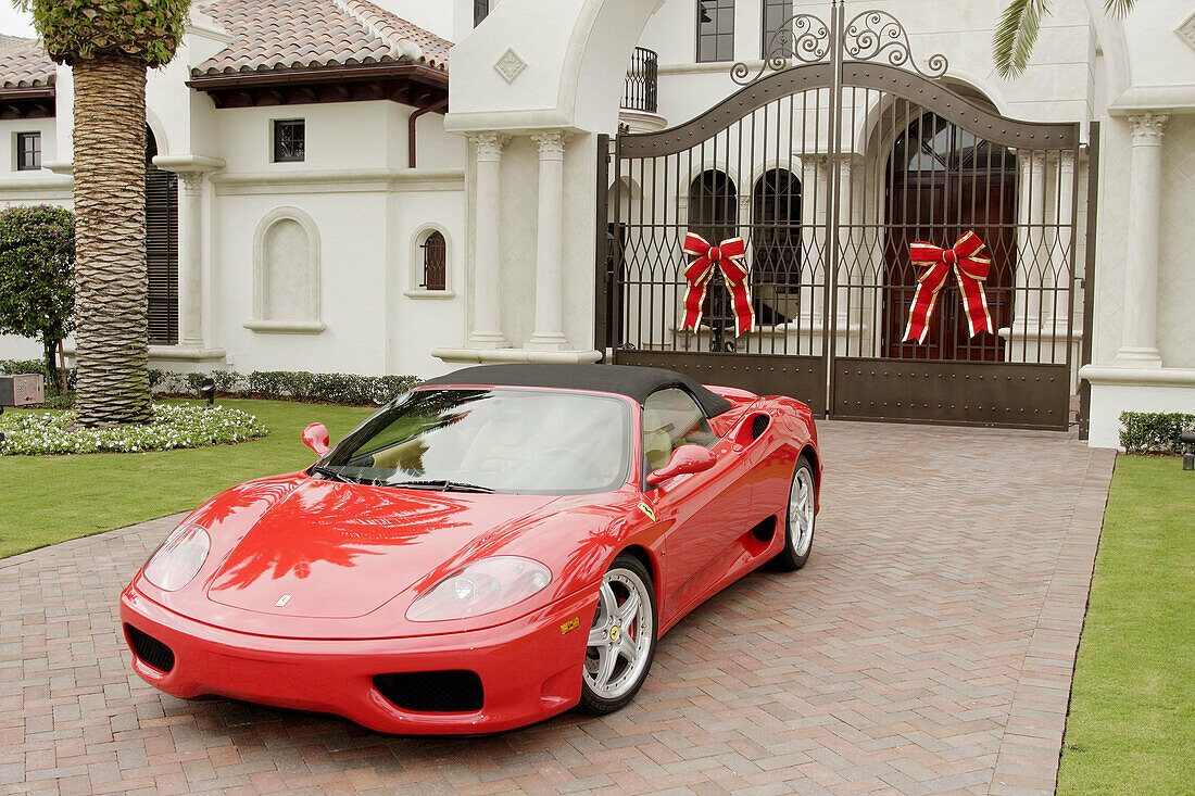 Florida,  Boca Raton,  Royal Palm,  gated community,  upscale,  rich,  upper income,  big,  house,  mansion,  luxury home,  McMansion,  driveway,  landscaping,  real estate,  Christmas decorations,  red,  Ferrari,  sports car,  ostentatious,  gate