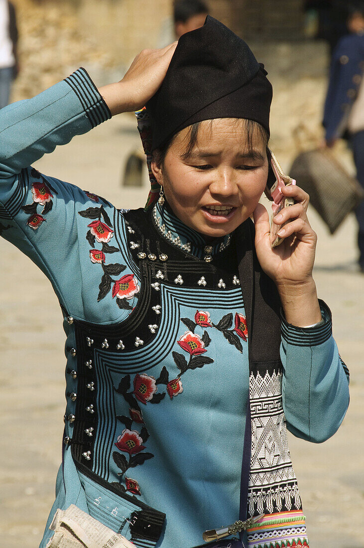 Hani woman on her cell phone in Yuanyang China