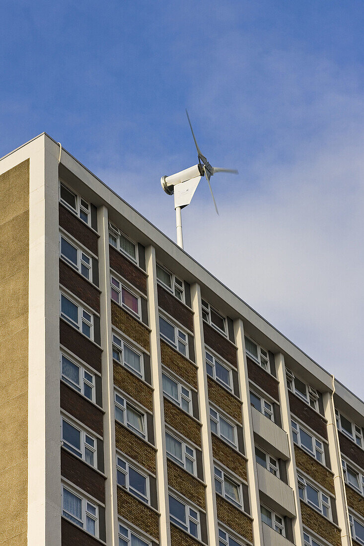 Wind turbine on top of a block of flats in north London,  England,  UK
