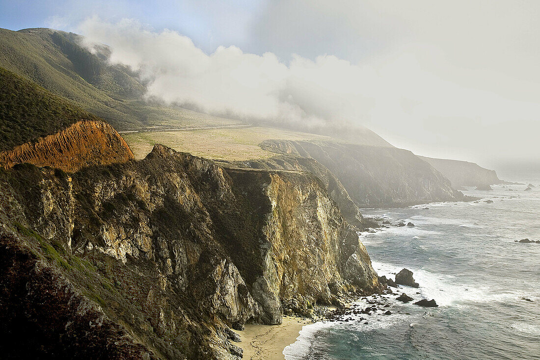 FOG AND DARK CLOUDS ROLL INTO HURRICANE POINT AT THE BIG SUR COASTLINE ALONG THE PACIFIC OCEAN,  CALIFORNIA