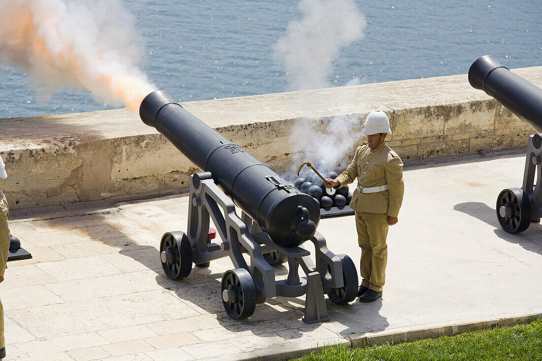 Firing of the noon day gun,  at the Saluting Battery,  Upper Barracca Gardens,  Valletta,  Malta