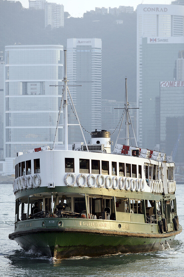 A traditional harbor ferry crossing Hong Kong harbor bay from Hong Kong Island to Kowloon at a sunny afternoon,  Hong Kong,  China,  Southeast Asia