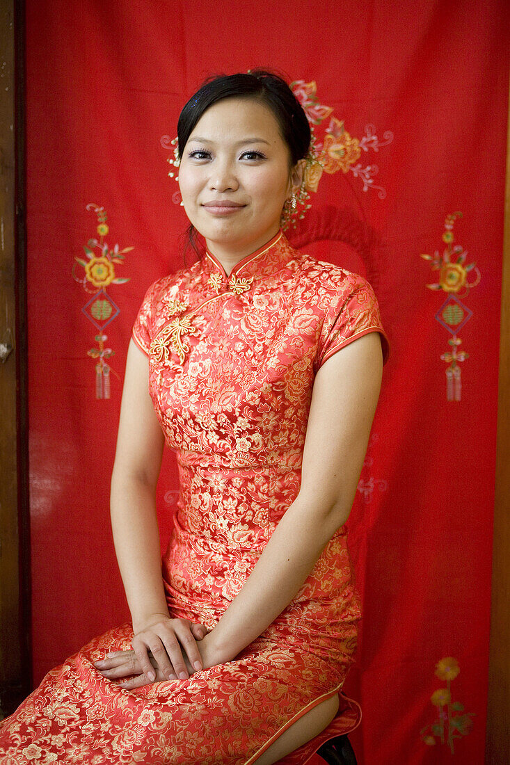 Bride wearing traditional Chinese clothing,  smiling at camera,  portrait