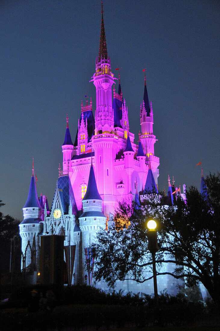 Evening illuminated view of Cinderella Castle at Walt Disney Magic Kingdom Theme Park Orlando Florida Central