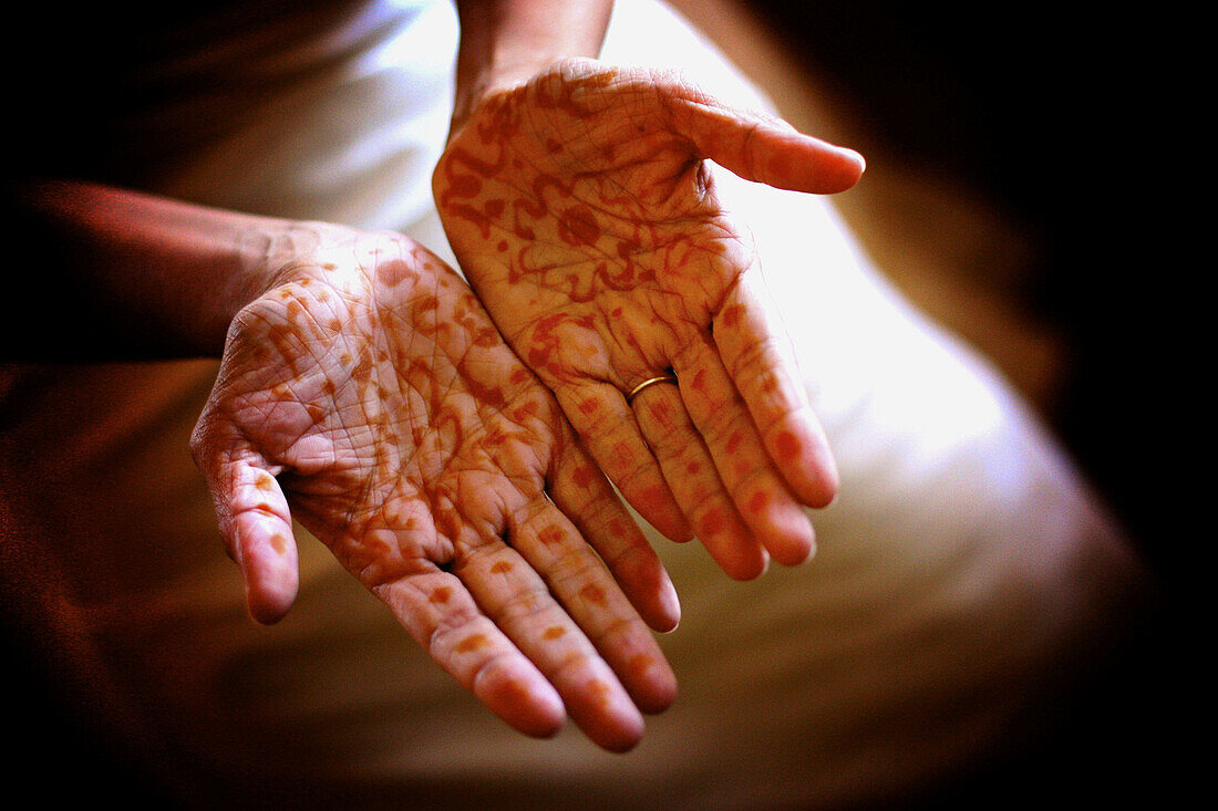 Brides hands with henna tattoos