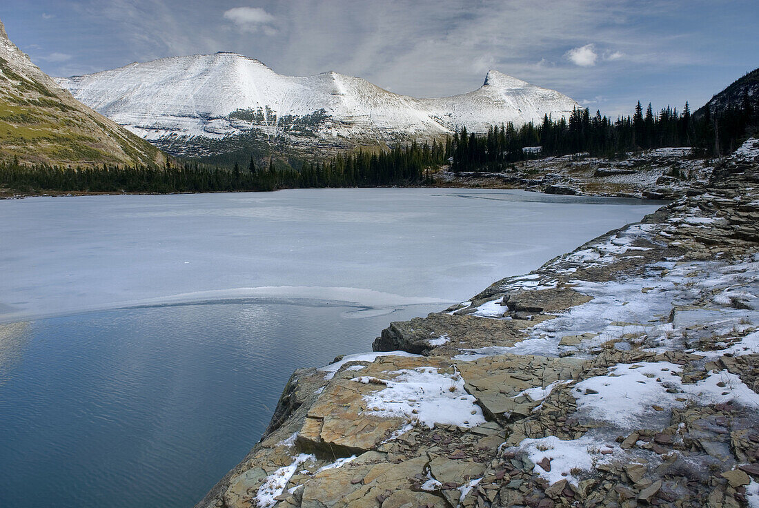 Lower Iceberg lake freezing over in late October,  Glacier National Park Montana USA