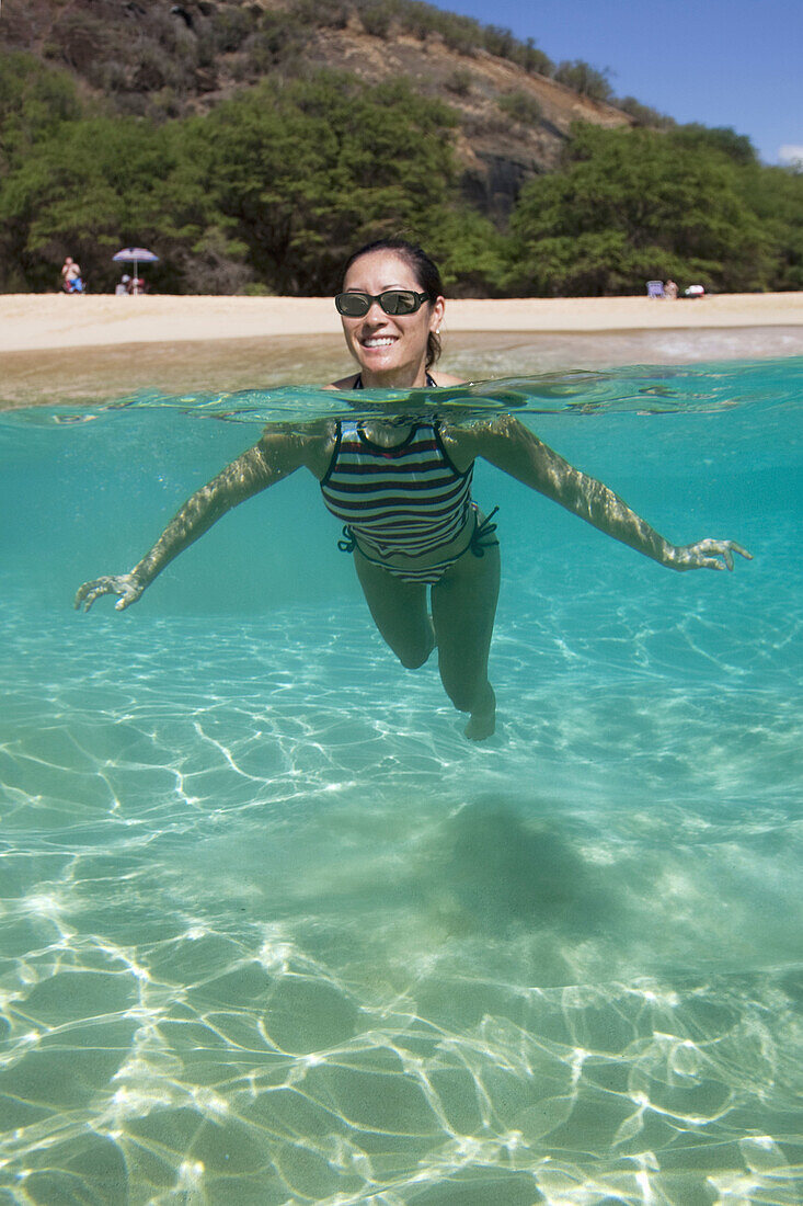 Woman swimming in the water  Maui,  Hawaii  Model released