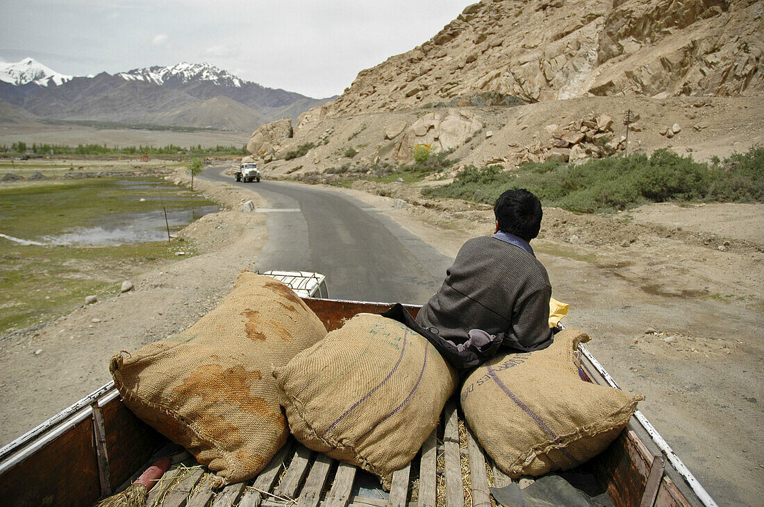 A man riding on the roof of a bus with the luggage Ladakh,  India
