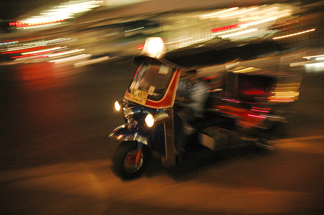 A tuk tuk speeding at night Bangkok,  Thailand