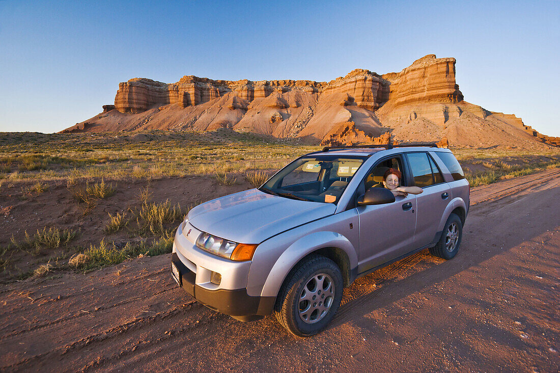 Woman in a SUV on a dirt road in Utah