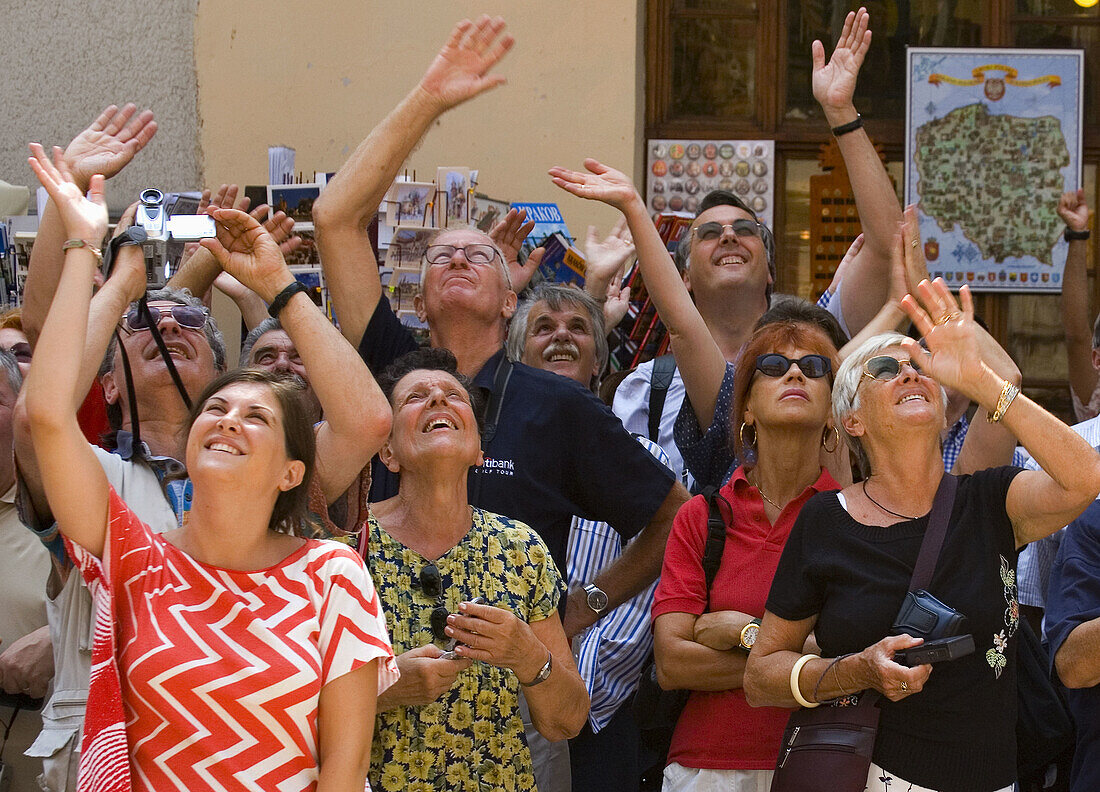 Poland Krakow Tourists watches as trumpeter plays anthem from St Mary´s Church Tower