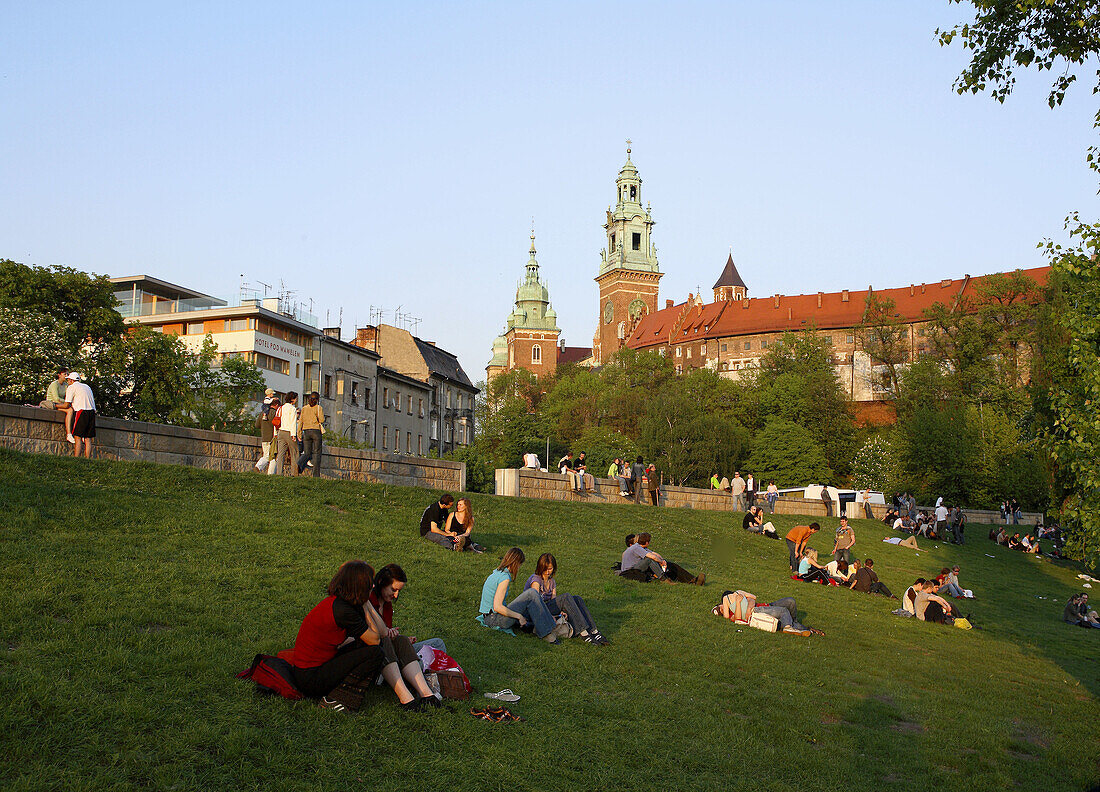 Poland,  Krakow,  people resting by Vistula river,  Wawel Hill