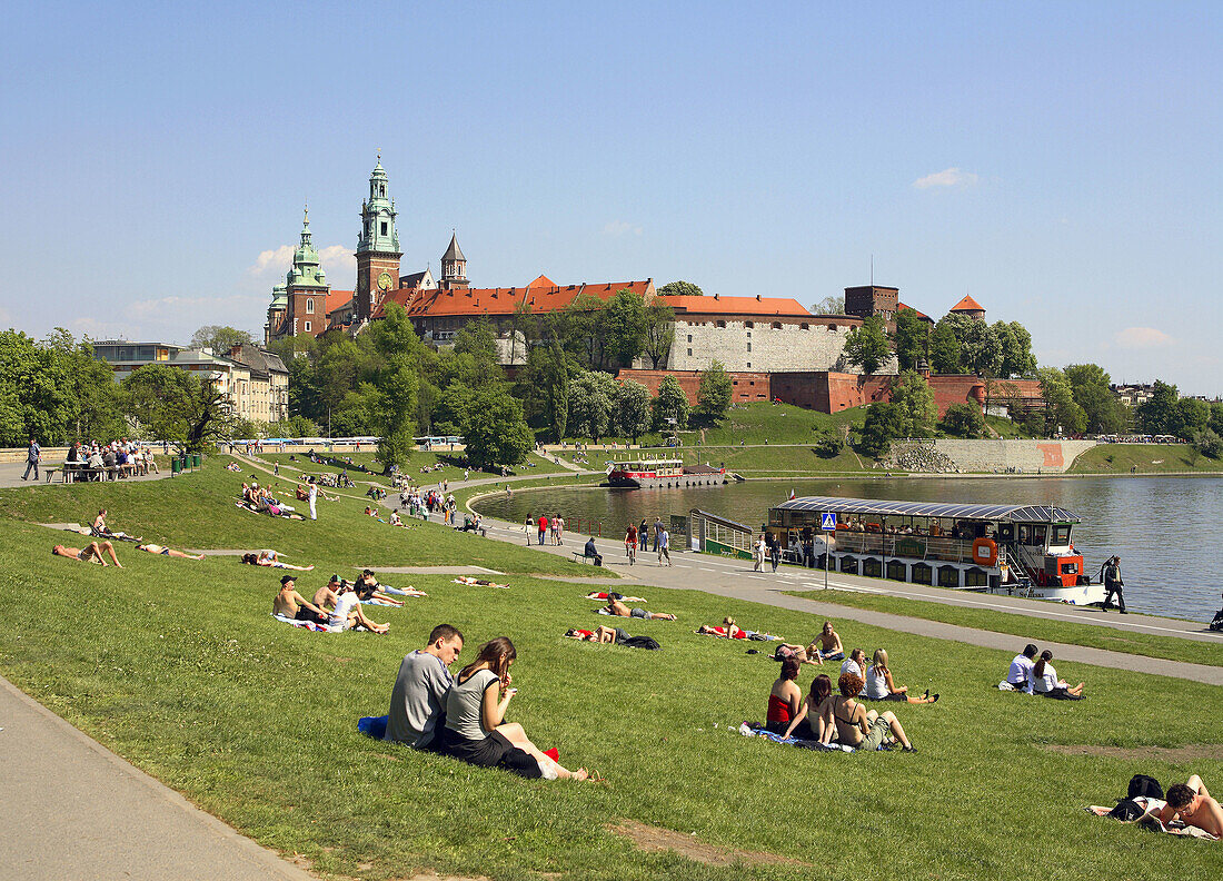 Poland,  Krakow,  people resting by Vistula river,  Wawel Hill