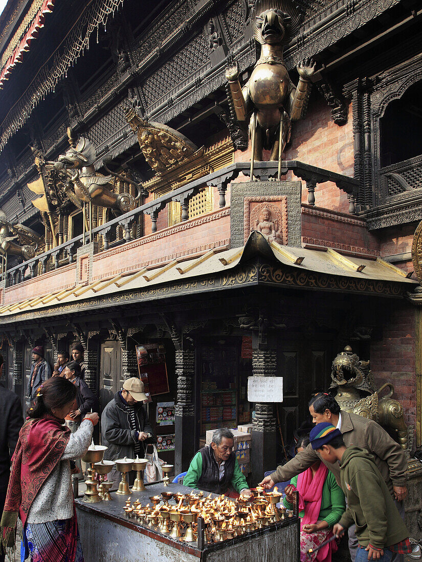 Nepal,  Kathmandu,  Indra Chowk,  Akash Bhairab shrine,  people,  butter lamp offerings